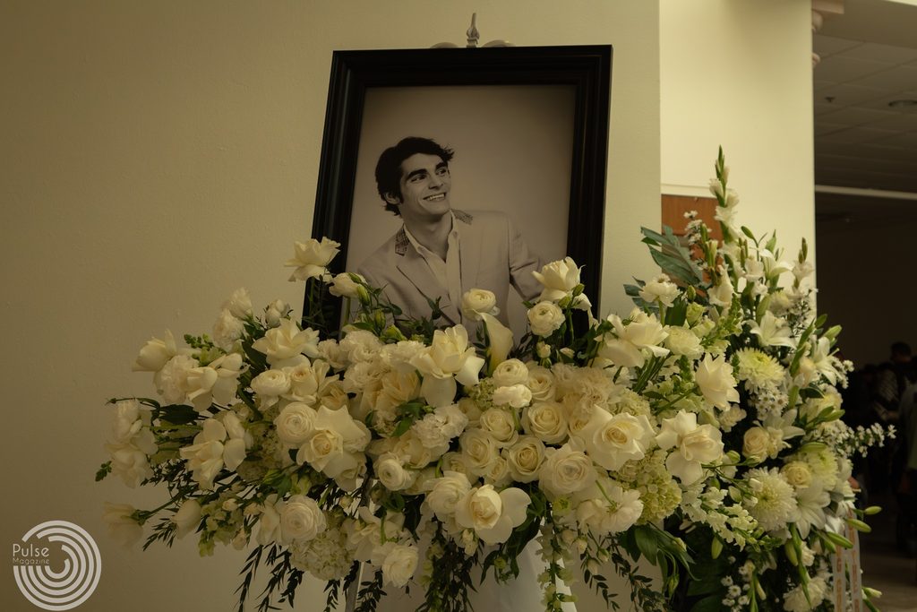 A portrait of actor RJ Mitte with flowers.